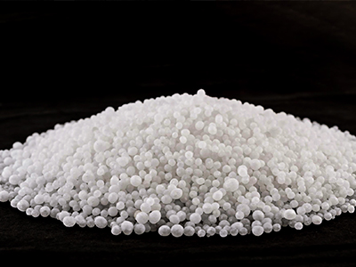 Close-up view of urea fertilizer granules showing texture and white crystalline structure