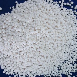 Calcium Chloride flakes or pellets, a white crystalline compound for industrial use.