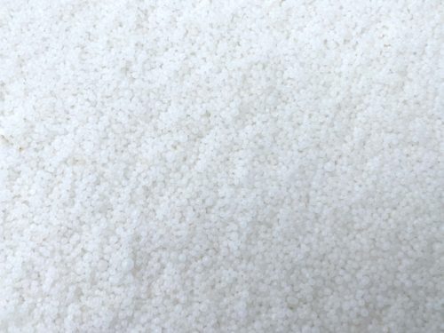 Agricultural prilled urea 46% nitrogen fertilizer granules close-up view
