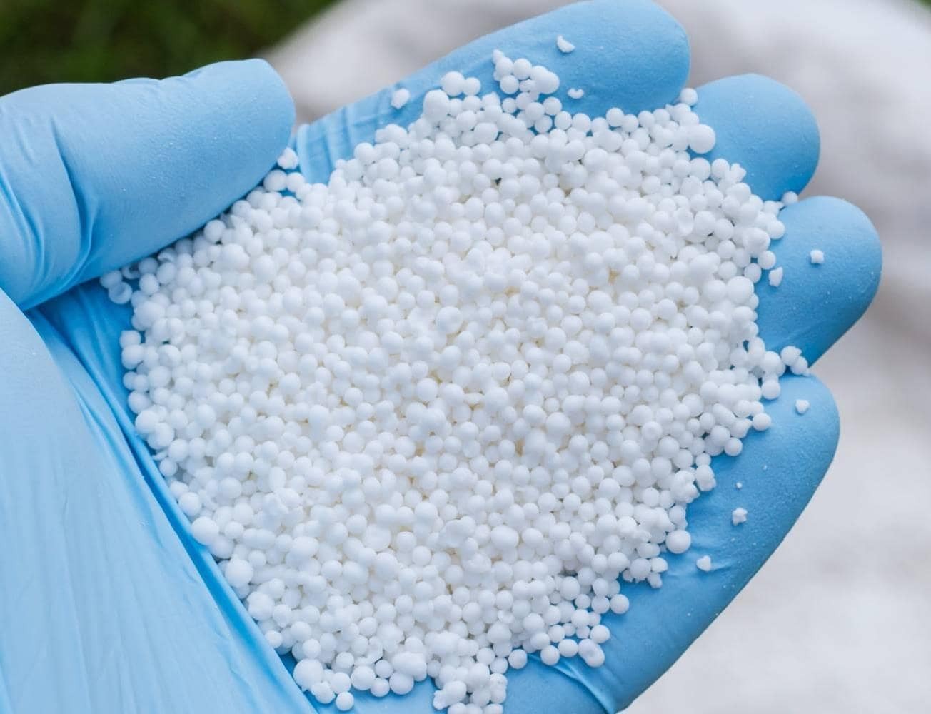 Close-up of white spherical Prilled Urea particles, ready for chemical processing
